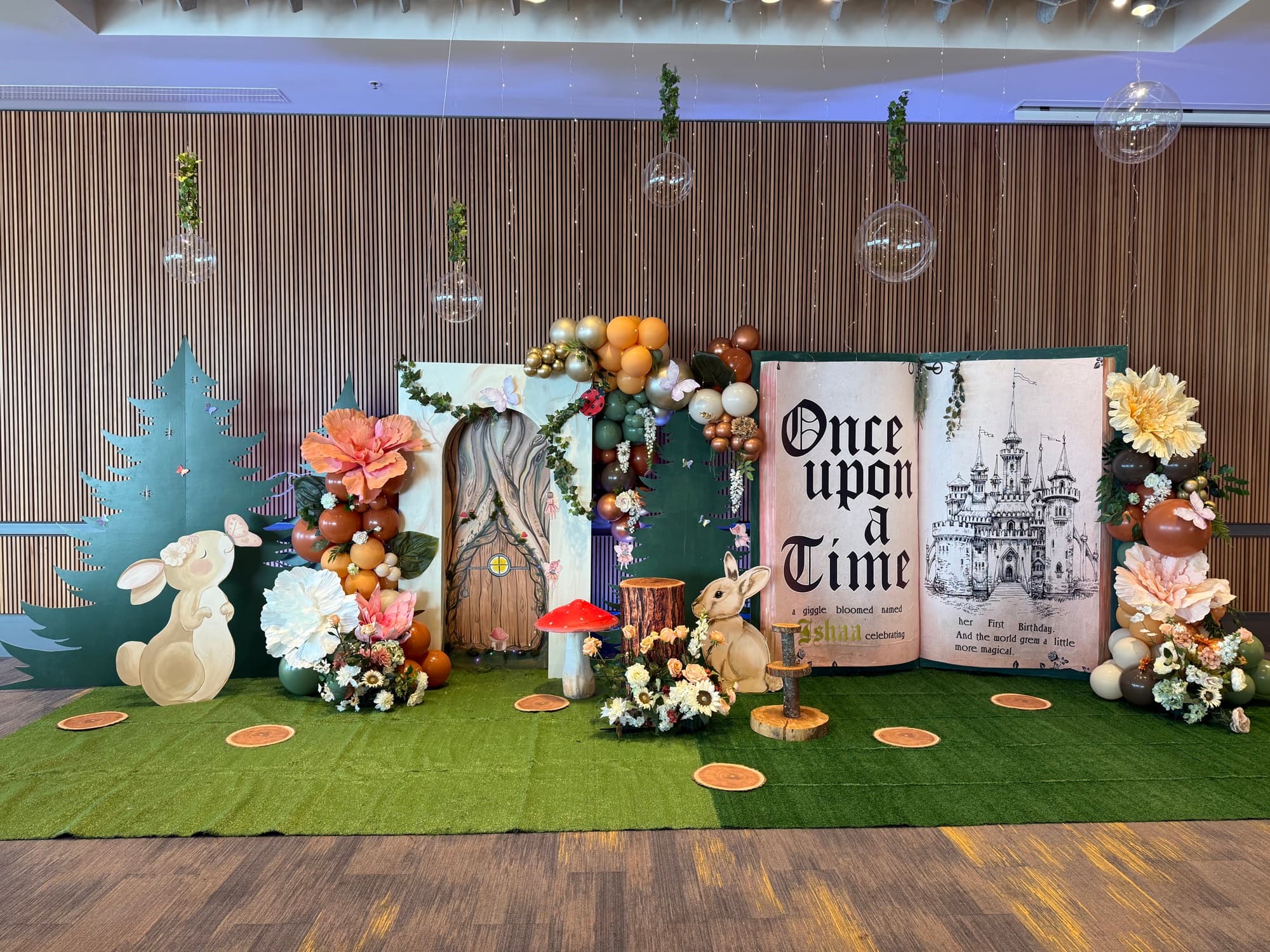 A wide storybook-themed celebration installation.
