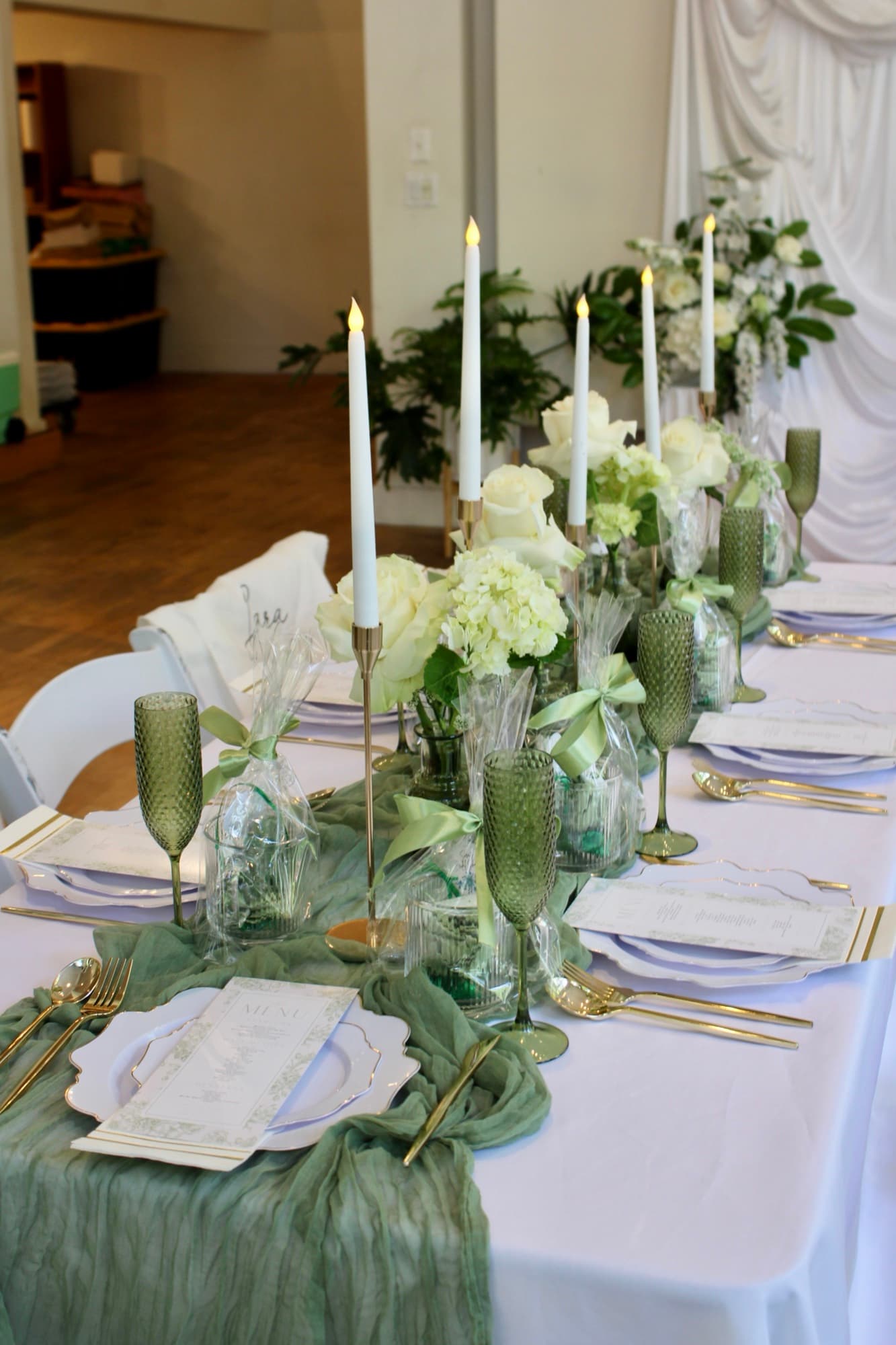 A wedding place setting with layered linens and floral accents.